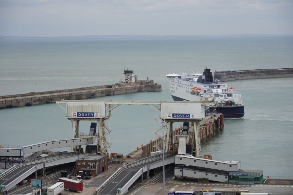Ferry departing from the iconic Port of Dover on a cloudy day.